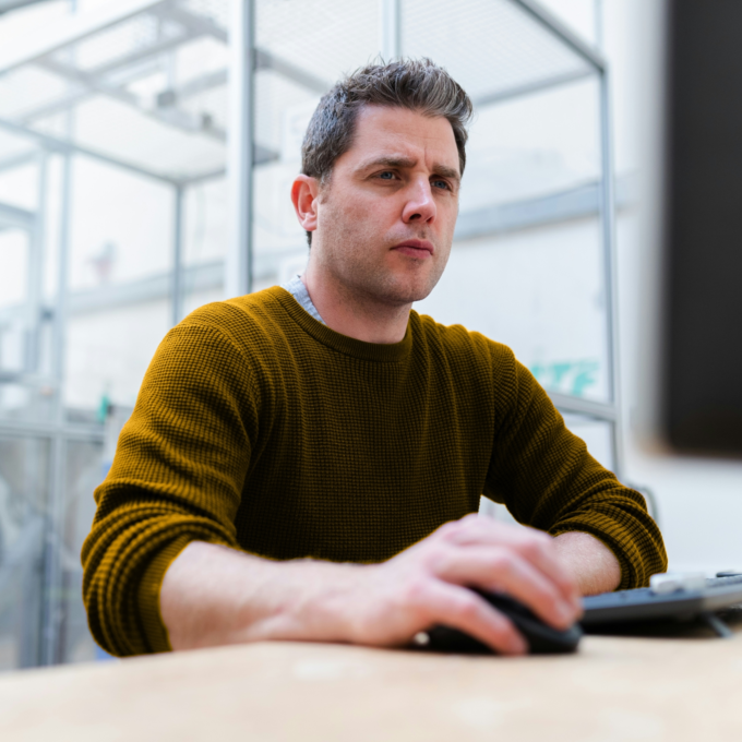 Man seated at computer contemplating using RRSP to pay off debt