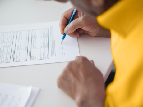 Man filling out a credit application after learning the difference between secured and unsecured debt