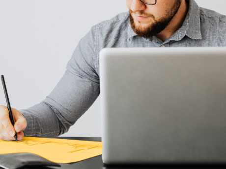 Man seated at a desk contemplating filing a consumer proposal